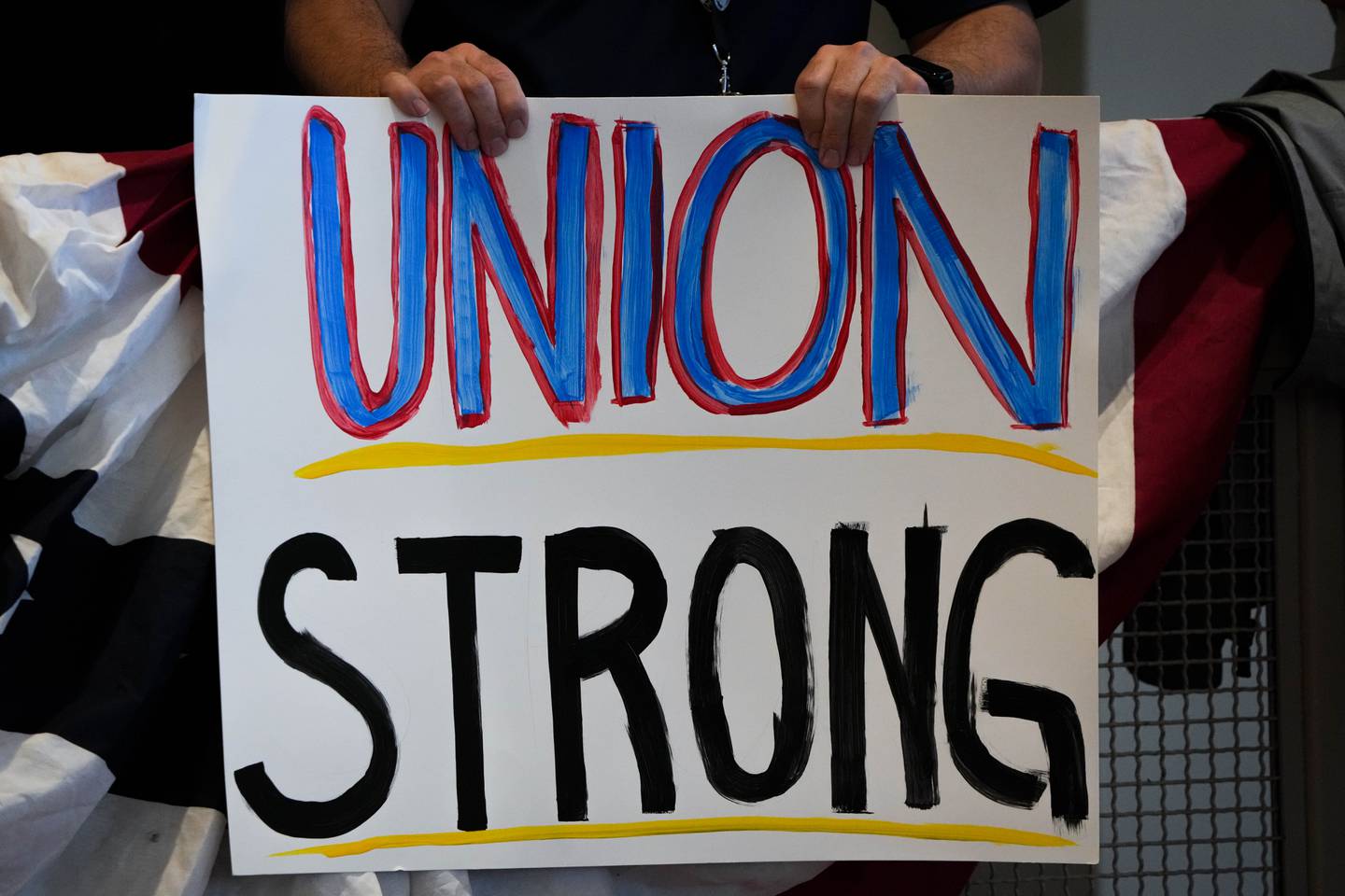 A union member holds a sign reading “Union Strong” during U.S. President Joe Biden’s visit to the IBEW Local 26 union at their office in Lanham, Maryland on 2/15/23.