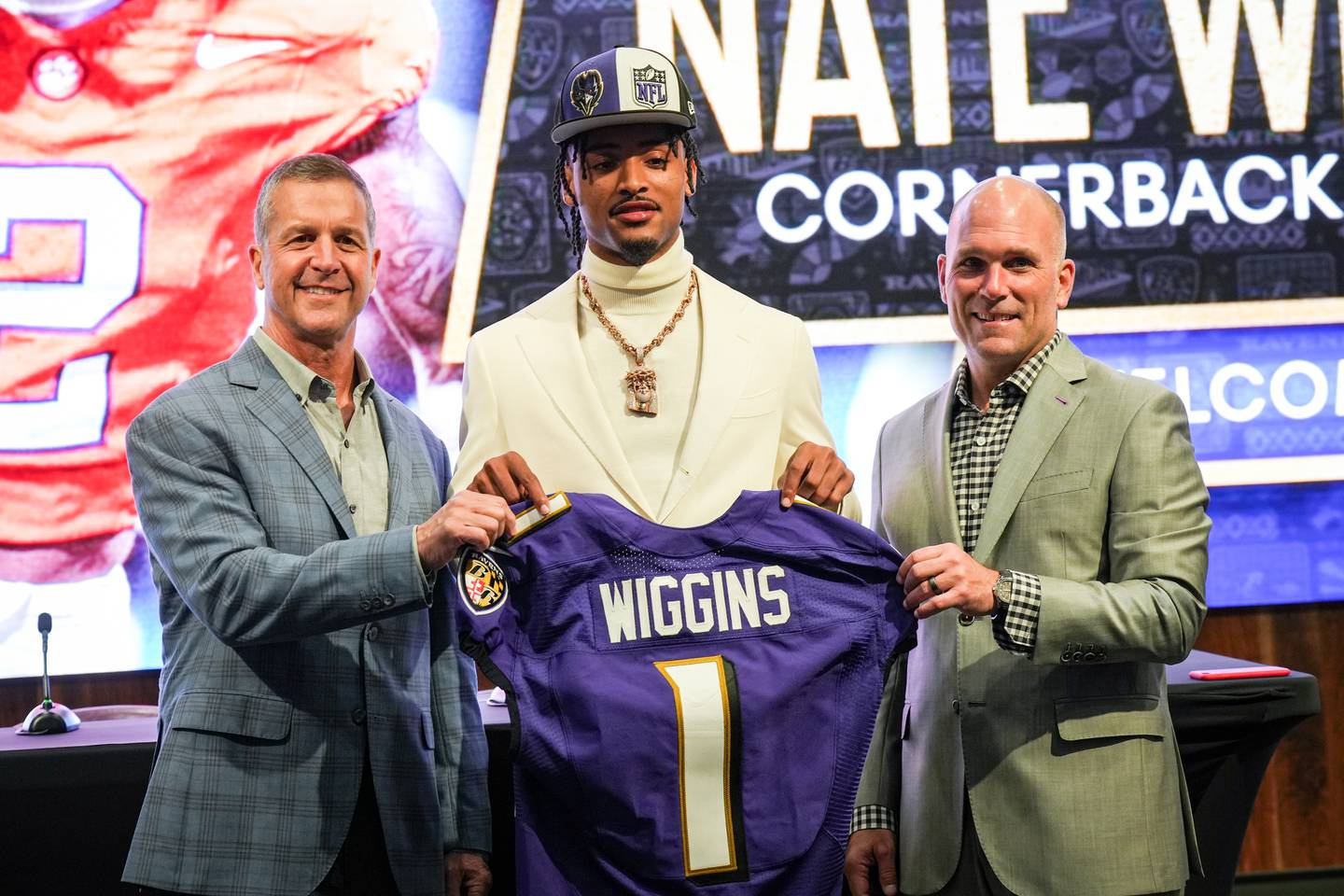 Clemson cornerback Nate Wiggins, the Baltimore Ravens’ first round pick in the 2024 NFL Draft, is introduced by head coach John Harbaugh (left) and general manager Eric DeCosta at a press conference at the Under Armour Performance Center on April 26, 2024.