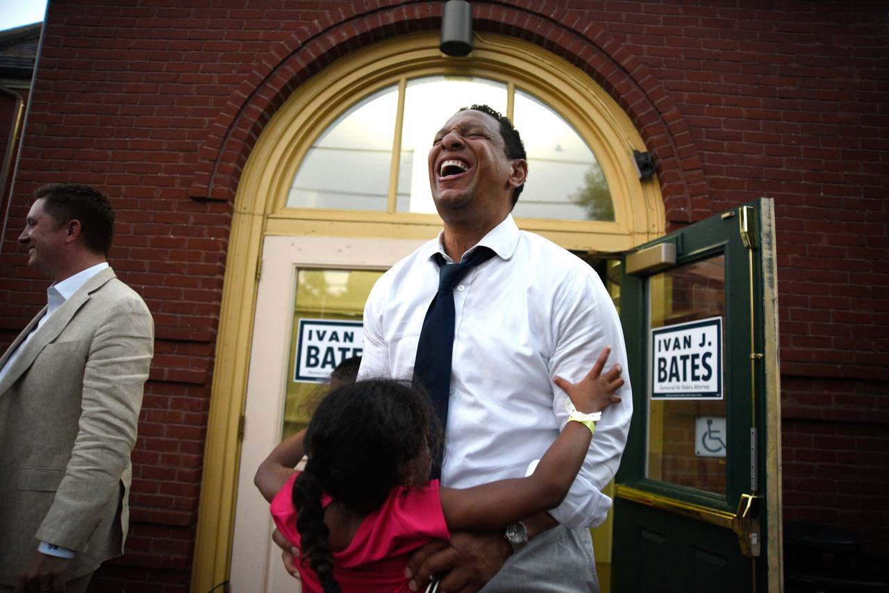 Baltimore City State's Attorney candidate Ivan Bates picks up his daughter, London, on Tuesday night at his election night event. Maryland held its primary election on Tuesday, July 19.
