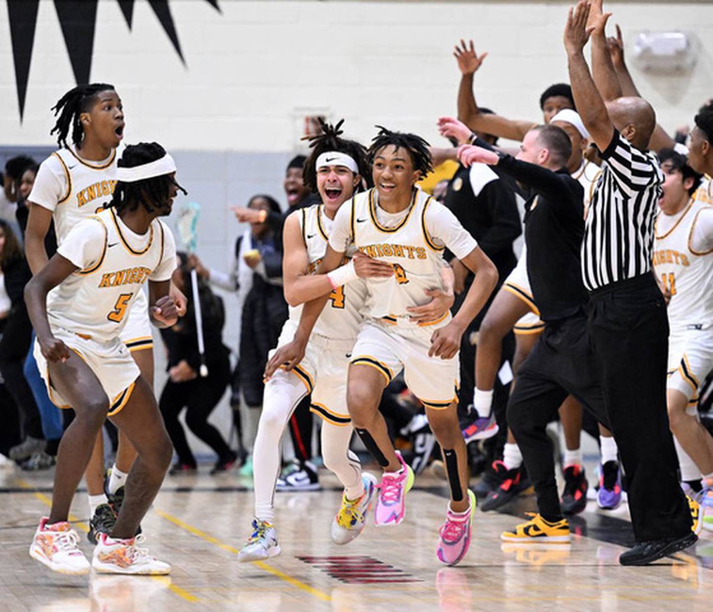 Parkville's Josiah Legree (far right) begins to celebrate after his game-winning 3-pointer in Thursday's Class 4A North Region I boys basketball championship game. His shot as time expired in overtime lifted the No. 5 Knights to a 67-66 victory over Dulaney for their third consecutive region title.