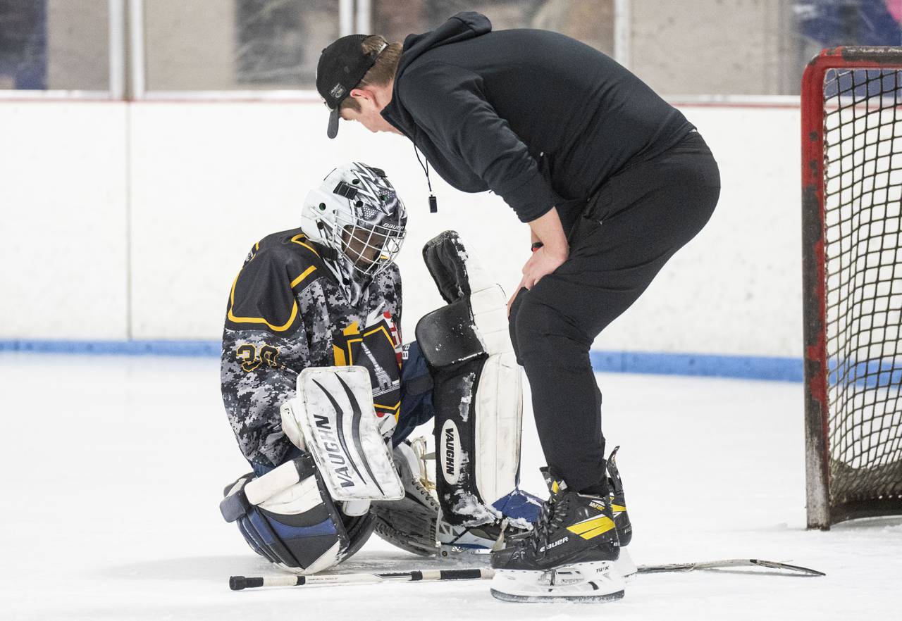 Baltimore Banner’s goalie, Larry Shanks is consoled by Baltimore Banner coach Taylor Handleton after being scored onduring a game at Mt. Pleasant Ice Arena, in Baltimore, March 26, 2023.