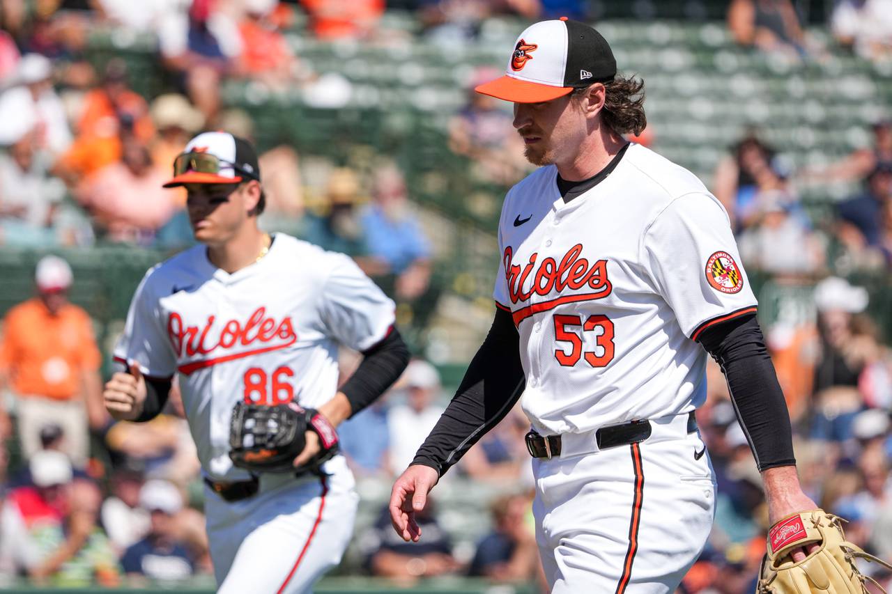 Baltimore Orioles relief pitcher Mike Baumann (53), with infielder Coby Mayo (86) next to him, returns to the dugout during a Grapefruit League game against the Detroit Tigers at Ed Smith Stadium on February 27, 2024.