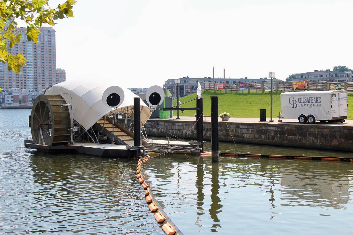 Mr. Trash Wheel sits in the water at the mouth of the Jones Falls on a sunny day.