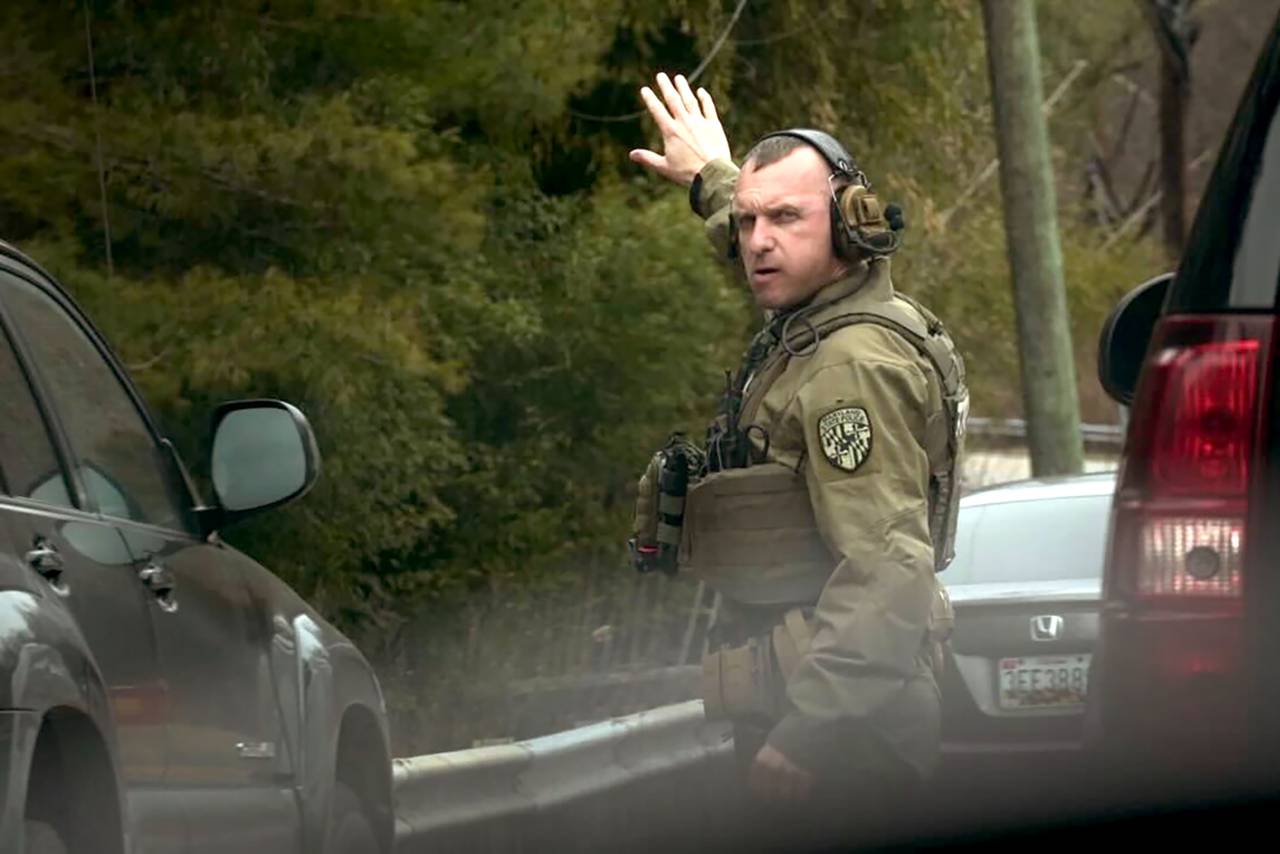 A Maryland State Police trooper directs traffic as the SWAT team conducts their search of a house on Warren Rd. during a manhunt for 24-year-old Cockeysville resident David Emory Linthicum.