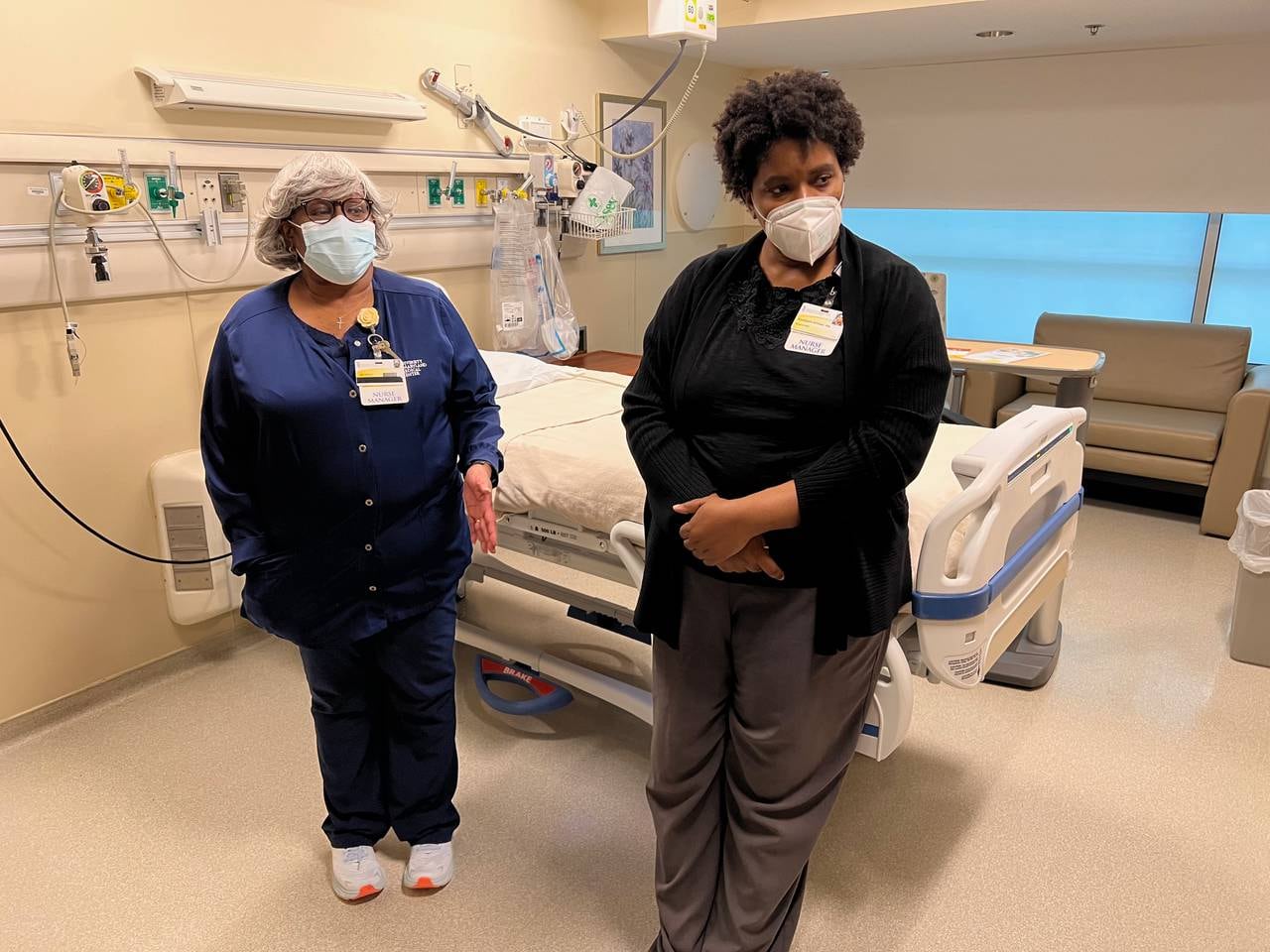 Barbara Bosah, right, nurse manager in the thoracic/surgical intermediate care unit and vascular progressive care unit, stands with surgical nurse manager Beverly Dukes in an empty hospital room at the University of Maryland Medical Center