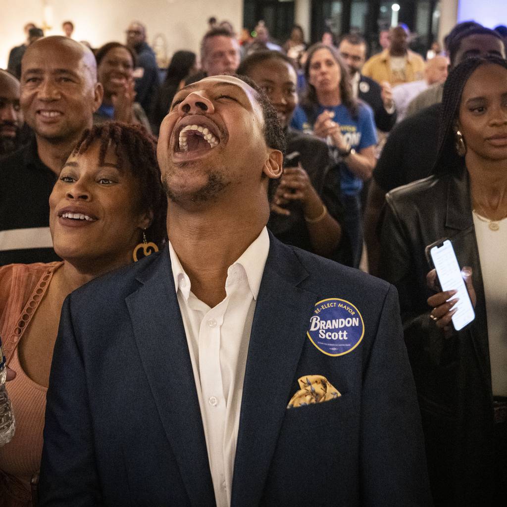 Tierra Taylor and James Lynch cheer as Baltimore Mayor Brandon Scott comes to the stage at Mayor Scott's election night event and watch party.